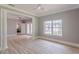 Open-concept living space with wood-look floors and ample natural light from large windows at 379 Bohannon Rd, Grantville, GA 30220