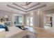 Spacious main bedroom with a tray ceiling, natural light, and a view of a connected sitting room at 379 Bohannon Rd, Grantville, GA 30220
