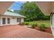 Delightful patio with red-stained wood deck, easy access, and beautifully landscaped garden with a grassy lawn in the distance at 379 Bohannon Rd, Grantville, GA 30220