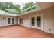 Wonderful patio with multi-door access and light-stained wood deck with an adjacent manicured lawn beyond at 379 Bohannon Rd, Grantville, GA 30220