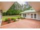 Lovely patio with red-stained wood deck and beautifully landscaped garden featuring red roses and manicured shrubbery at 379 Bohannon Rd, Grantville, GA 30220