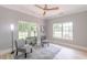 Cozy sitting room with natural light, stylish decor, wood flooring, and comfortable seating arrangement at 379 Bohannon Rd, Grantville, GA 30220