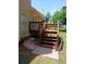 Cozy backyard with wooden deck and stone path, creating a welcoming outdoor space at 5517 Rock Shoals Way, Atlanta, GA 30349