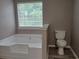 Bathroom with jacuzzi tub, new hardwood floors and toilet at 5517 Rock Shoals Way, Atlanta, GA 30349