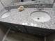 Bathroom vanity with double sink and granite countertop plus modern fixtures and stylish cabinets at 5517 Rock Shoals Way, Atlanta, GA 30349