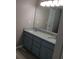 Bathroom with double vanity, granite countertops, and gray wood-look floors at 5517 Rock Shoals Way, Atlanta, GA 30349