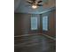 This bedroom features hard floors, two windows with blinds, and a ceiling fan at 5517 Rock Shoals Way, Atlanta, GA 30349