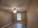 Comfortable bedroom features a ceiling fan, wood-look floors, and natural light from the window at 5517 Rock Shoals Way, Atlanta, GA 30349