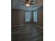 Bedroom with ceiling fan, tray ceiling, and two windows at 5517 Rock Shoals Way, Atlanta, GA 30349