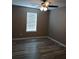 Bedroom with hardwood flooring, ceiling fan, and window at 5517 Rock Shoals Way, Atlanta, GA 30349