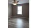 Bedroom with hardwood flooring, ceiling fan, and window at 5517 Rock Shoals Way, Atlanta, GA 30349