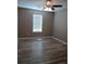 Bedroom with hardwood flooring, ceiling fan, and window at 5517 Rock Shoals Way, Atlanta, GA 30349