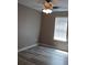 Bedroom with hardwood flooring, ceiling fan, and window at 5517 Rock Shoals Way, Atlanta, GA 30349