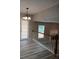 The dining area has a modern chandelier and French doors at 5517 Rock Shoals Way, Atlanta, GA 30349