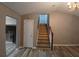 Entryway showing stairs with hardwood flooring, door to the left, and dark trim at 5517 Rock Shoals Way, Atlanta, GA 30349