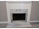 Close up of a fireplace, featuring marble and a white wooden mantel at 5517 Rock Shoals Way, Atlanta, GA 30349