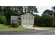 Charming home features a two-car garage and a well-manicured front yard at 5517 Rock Shoals Way, Atlanta, GA 30349