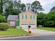 Charming two-story home with a well-manicured lawn, a two-car garage, and a welcoming green front door at 5517 Rock Shoals Way, Atlanta, GA 30349