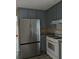Well-lit kitchen featuring stainless steel fridge, oven, and cabinets at 5517 Rock Shoals Way, Atlanta, GA 30349
