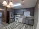 Kitchen featuring stainless steel appliances and grey cabinets at 5517 Rock Shoals Way, Atlanta, GA 30349