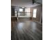 View of living room that opens to the kitchen and natural light, separated by white railing at 5517 Rock Shoals Way, Atlanta, GA 30349