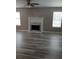 The living room has a fireplace, hardwood floors, and natural light from two windows at 5517 Rock Shoals Way, Atlanta, GA 30349