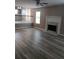 Open floor plan living room showcasing a fireplace, modern floors, and large windows at 5517 Rock Shoals Way, Atlanta, GA 30349
