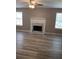 The living room has a fireplace, hardwood floors, and natural light at 5517 Rock Shoals Way, Atlanta, GA 30349