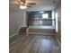 View of living room that opens to kitchen, separated by white railing and steps at 5517 Rock Shoals Way, Atlanta, GA 30349