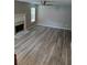 Bright living room boasts hard floors, fireplace, and a large window at 5517 Rock Shoals Way, Atlanta, GA 30349