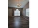 Open living room features high ceilings, laminate flooring, and natural light at 5517 Rock Shoals Way, Atlanta, GA 30349