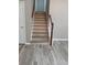 Staircase with woodgrain vinyl steps and railing at 5517 Rock Shoals Way, Atlanta, GA 30349