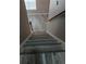 Staircase with woodgrain vinyl steps and railing, looking down at 5517 Rock Shoals Way, Atlanta, GA 30349
