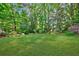 Expansive backyard with lush greenery, mature trees, and a wooden fence at 1146 Cumberland Ne Rd, Atlanta, GA 30306