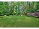 Spacious backyard with lush greenery, mature trees, and a wooden fence at 1146 Cumberland Ne Rd, Atlanta, GA 30306