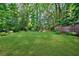 Lush green backyard surrounded by mature trees, offering a private and serene outdoor space at 1146 Cumberland Ne Rd, Atlanta, GA 30306