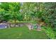 Picturesque backyard featuring stone retaining wall, lush greenery, and established trees at 1146 Cumberland Ne Rd, Atlanta, GA 30306