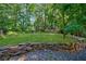 Private backyard with a stone wall and mature trees at 1146 Cumberland Ne Rd, Atlanta, GA 30306