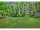 Expansive backyard with lush greenery and mature trees providing privacy and a natural setting at 1146 Cumberland Ne Rd, Atlanta, GA 30306