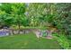Lush backyard with stone accents, tiered landscaping, and mature trees at 1146 Cumberland Ne Rd, Atlanta, GA 30306