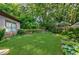 Serene backyard featuring a stone retaining wall and lush landscaping at 1146 Cumberland Ne Rd, Atlanta, GA 30306