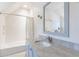 Bright bathroom featuring a tub, white subway tiles, neutral countertops, and modern fixtures at 1146 Cumberland Ne Rd, Atlanta, GA 30306