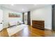Well-lit bedroom with hardwood floors, a large dresser, two chairs, and tasteful decor at 1146 Cumberland Ne Rd, Atlanta, GA 30306