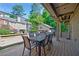 Outdoor deck area with wooden railing, ample seating, and scenic views of the surrounding landscape at 1146 Cumberland Ne Rd, Atlanta, GA 30306