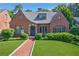 Charming brick home with manicured lawn, lush greenery, and inviting entryway; a beautiful suburban residence at 1146 Cumberland Ne Rd, Atlanta, GA 30306