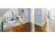Upstairs landing with reading nook and adjacent rooms featuring rich hardwood floors at 1146 Cumberland Ne Rd, Atlanta, GA 30306