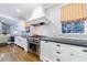 Modern kitchen featuring white cabinets, stainless steel appliances, and hardwood floors at 1146 Cumberland Ne Rd, Atlanta, GA 30306