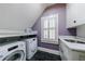 Practical laundry room featuring modern machines, sleek countertops and a sunlit window at 1146 Cumberland Ne Rd, Atlanta, GA 30306