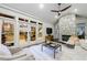 A cozy living room with stone fireplace and views of the outdoor patio at 1146 Cumberland Ne Rd, Atlanta, GA 30306