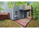 View of the back of the house with a brick patio and lush greenery at 212 Ranier Court, Canton, GA 30114